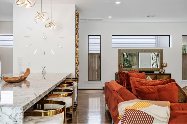 living room featuring an inviting chandelier and dark hardwood / wood-style floors