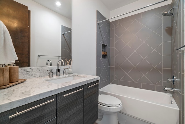 full bathroom with vanity, toilet, and tiled shower / bath combo