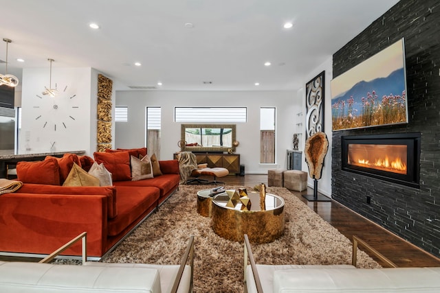 living room featuring a large fireplace and hardwood / wood-style floors