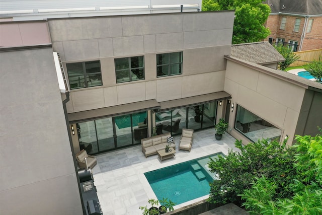 rear view of house with an outdoor hangout area and a patio