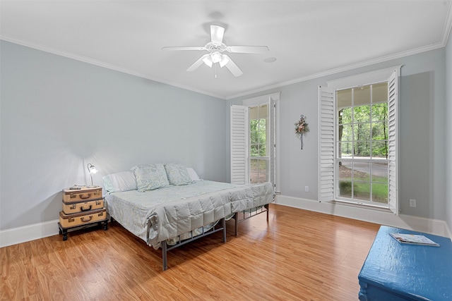 bedroom with ceiling fan, light wood-type flooring, and ornamental molding