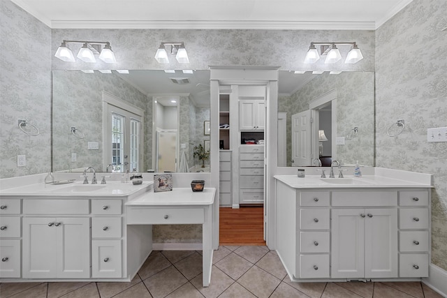 full bathroom with a sink, visible vents, ornamental molding, and wallpapered walls