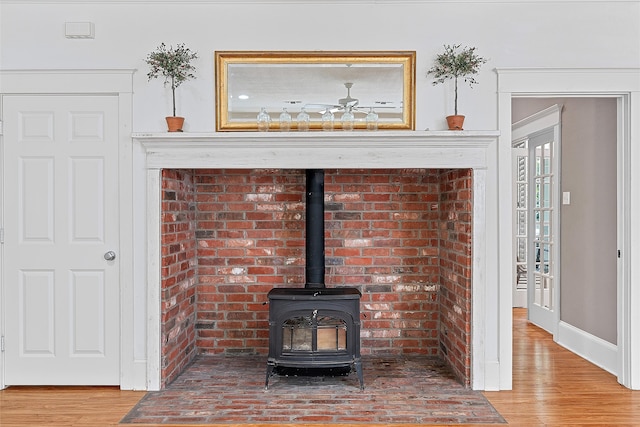 room details featuring hardwood / wood-style flooring and a wood stove