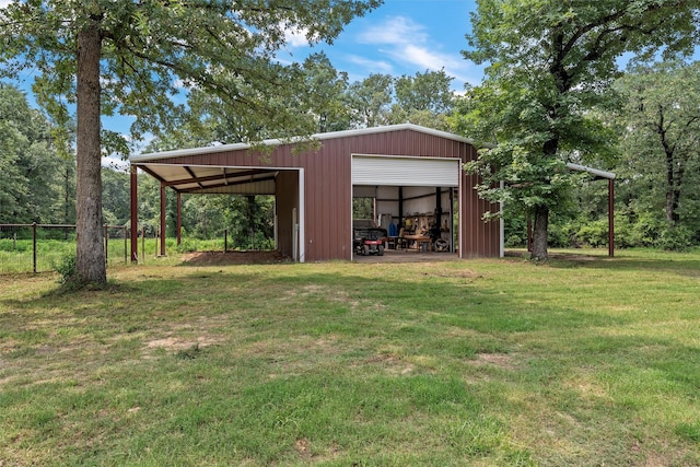 view of pole building with a lawn and fence