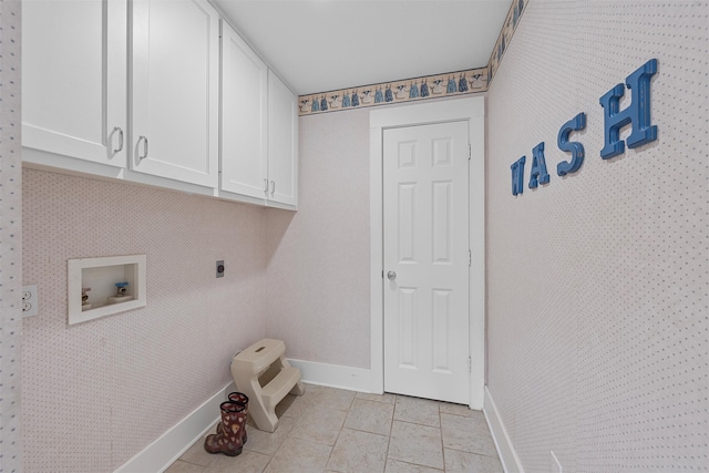 laundry room with baseboards, light tile patterned floors, hookup for a washing machine, cabinet space, and hookup for an electric dryer