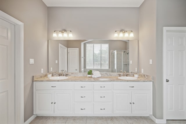 bathroom featuring vanity, tile patterned floors, and a shower with door