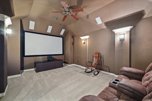 cinema room featuring light carpet, ceiling fan, and vaulted ceiling