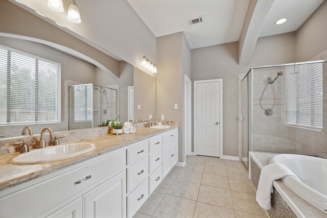 bathroom with tile patterned floors, separate shower and tub, and vanity