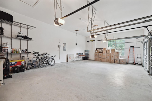 garage with electric panel and a garage door opener