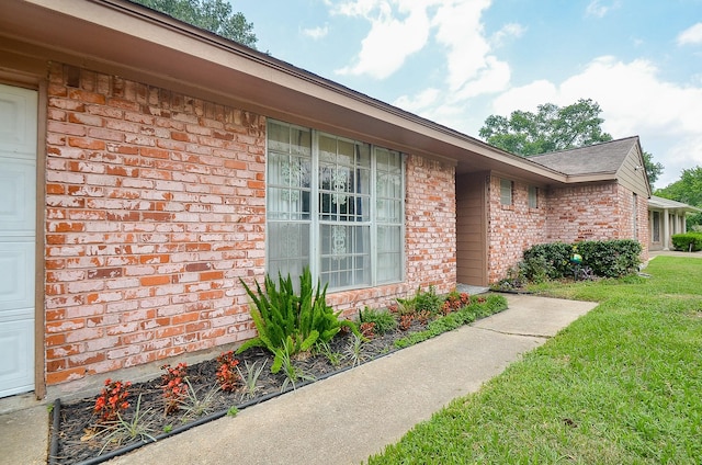 property entrance with a lawn