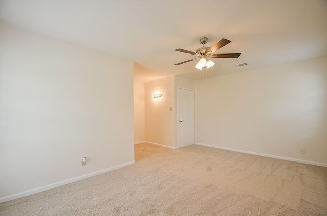 carpeted spare room with ceiling fan