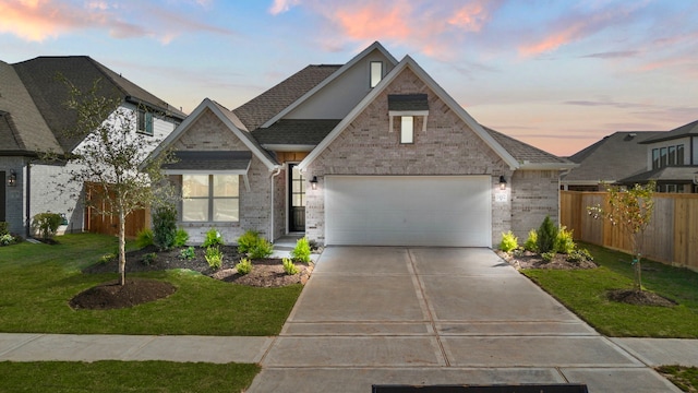 view of front of property featuring a yard and a garage