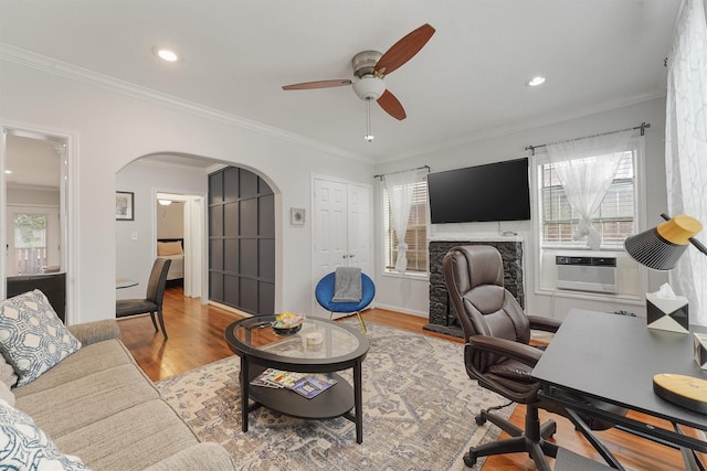 office space featuring ceiling fan, light hardwood / wood-style floors, ornamental molding, and cooling unit