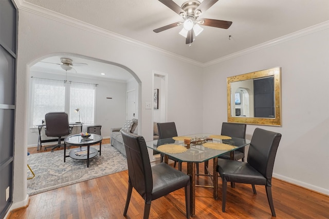 dining space with ceiling fan, hardwood / wood-style floors, and crown molding