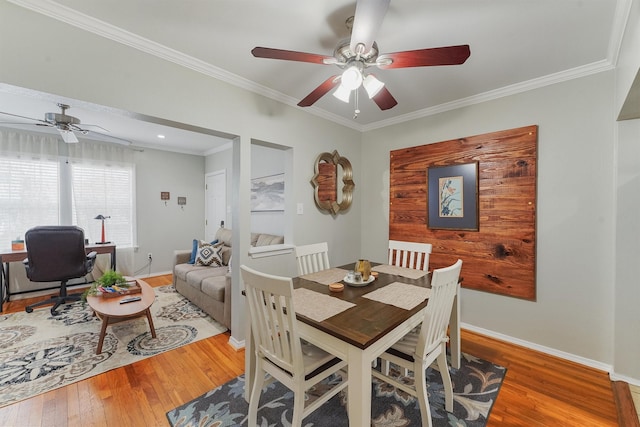 dining room with crown molding, ceiling fan, and wood-type flooring