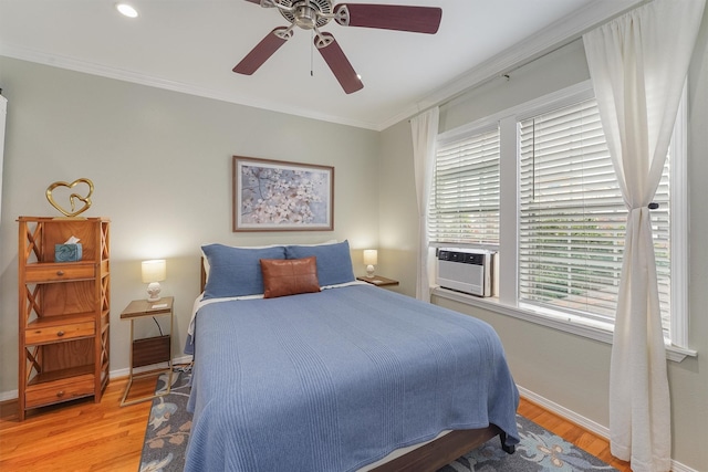 bedroom featuring hardwood / wood-style floors, ceiling fan, cooling unit, and ornamental molding