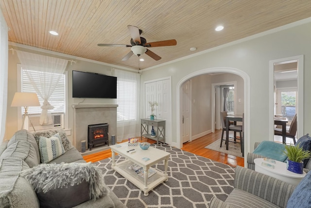 living room with hardwood / wood-style floors, cooling unit, ceiling fan, ornamental molding, and wood ceiling