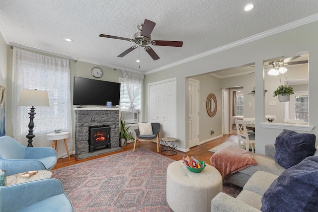 living room with hardwood / wood-style flooring, ornamental molding, and a textured ceiling