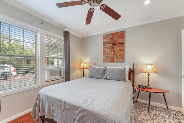 bedroom featuring cooling unit, light hardwood / wood-style flooring, ceiling fan, and crown molding