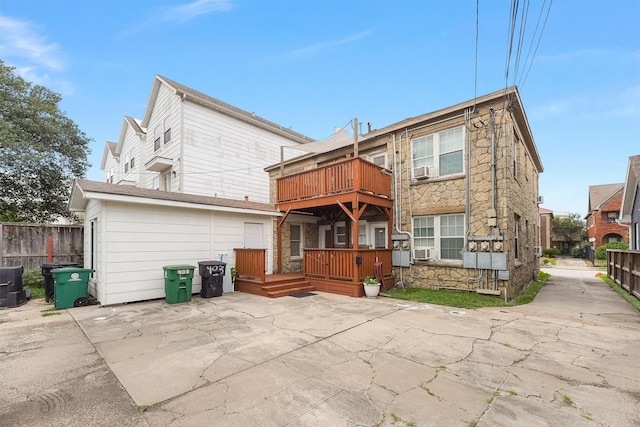 rear view of house with a deck and a patio