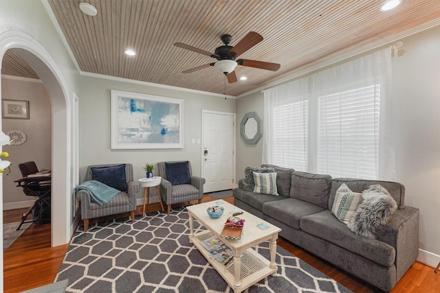 living room with wooden ceiling, hardwood / wood-style flooring, ceiling fan, and ornamental molding