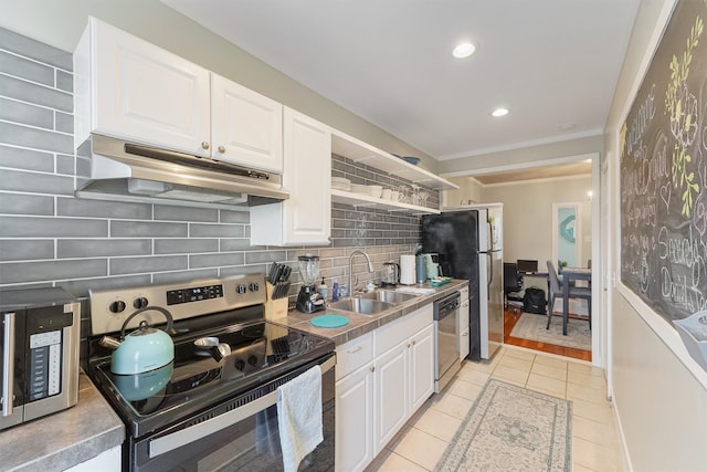 kitchen featuring white cabinets, stainless steel appliances, ornamental molding, and sink