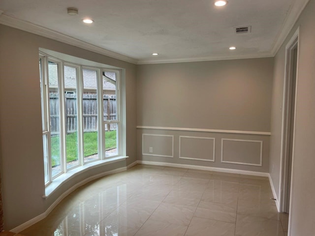 unfurnished room featuring crown molding