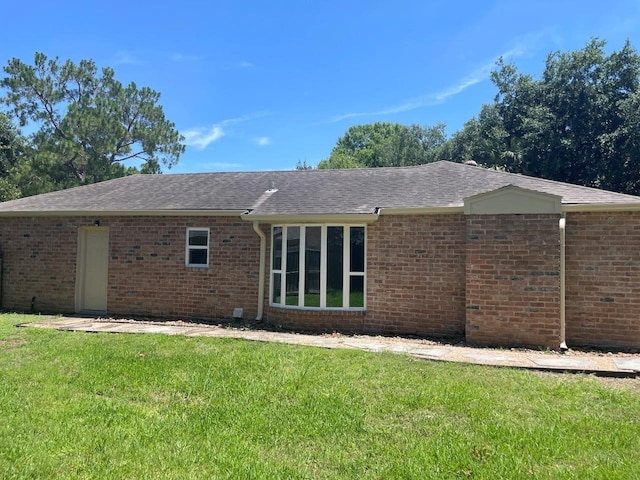 rear view of property with a lawn