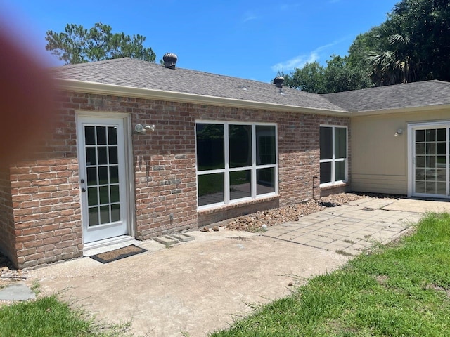 rear view of property featuring a patio area