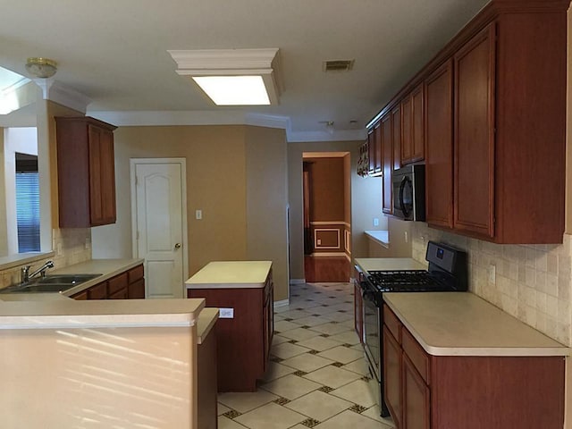 kitchen featuring decorative backsplash, ornamental molding, sink, black gas range, and a center island