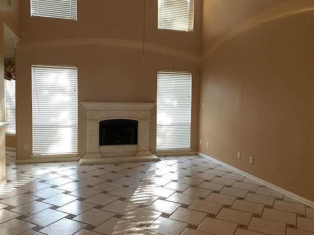 unfurnished living room with a high ceiling