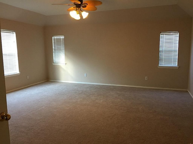 empty room with carpet flooring, ceiling fan, and vaulted ceiling