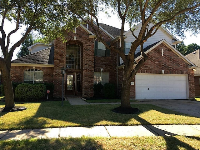 view of property featuring a garage and a front lawn