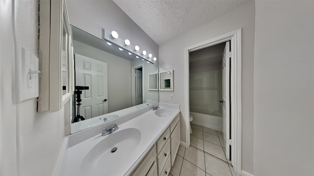 full bathroom with vanity, a textured ceiling, shower / washtub combination, tile patterned flooring, and toilet