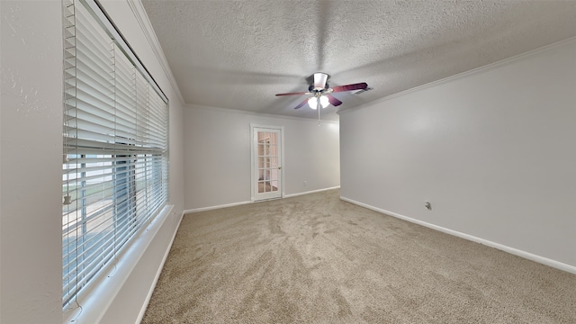 carpeted spare room with ceiling fan, ornamental molding, and a textured ceiling