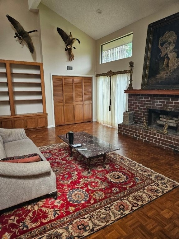 living room featuring high vaulted ceiling, dark parquet floors, a brick fireplace, and a textured ceiling