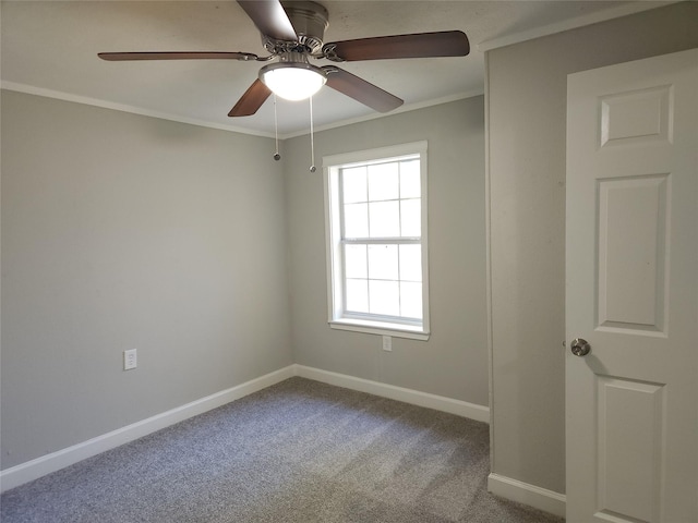 empty room featuring carpet, ceiling fan, and ornamental molding