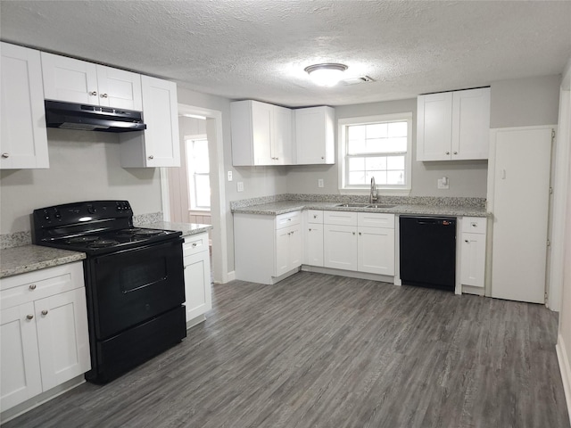 kitchen featuring white cabinetry, sink, dark wood-type flooring, a textured ceiling, and black appliances