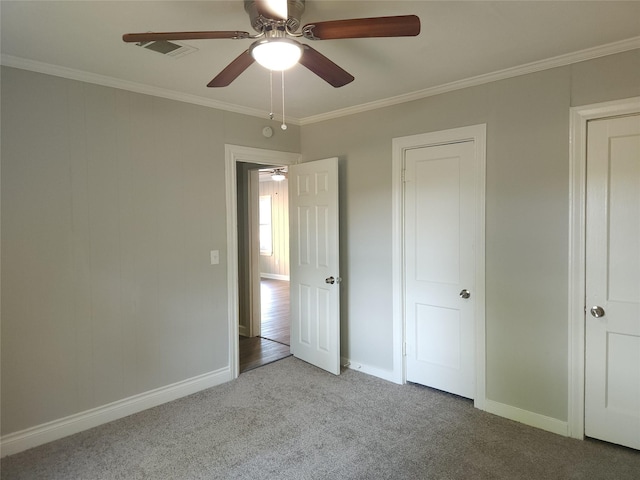 unfurnished bedroom with ceiling fan, crown molding, and light carpet