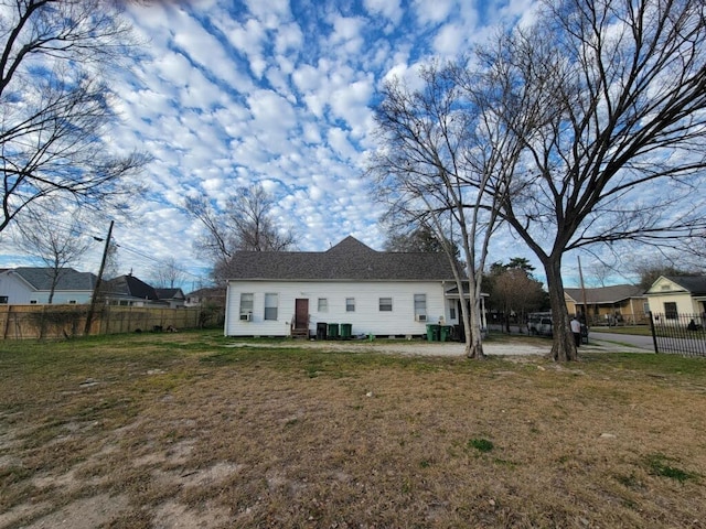 rear view of property with a yard