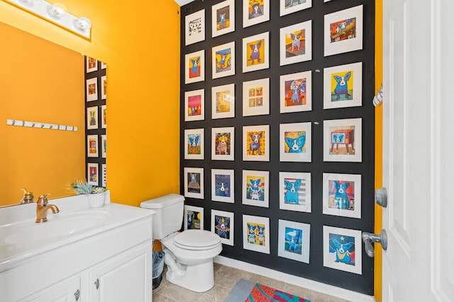 bathroom featuring tile patterned floors, vanity, and toilet