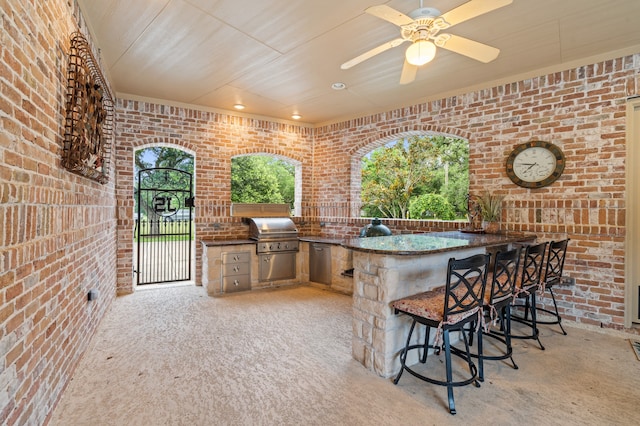 view of patio / terrace featuring area for grilling, an outdoor bar, grilling area, and ceiling fan