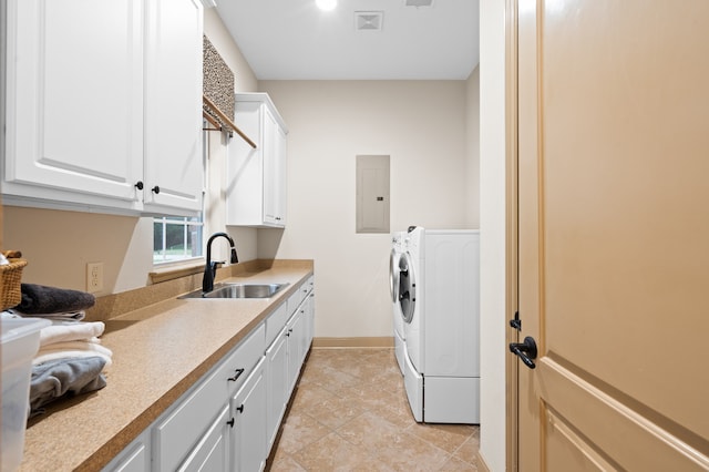 laundry room featuring cabinets, sink, washer and dryer, electric panel, and light tile patterned flooring