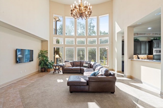 living room featuring a towering ceiling and a chandelier