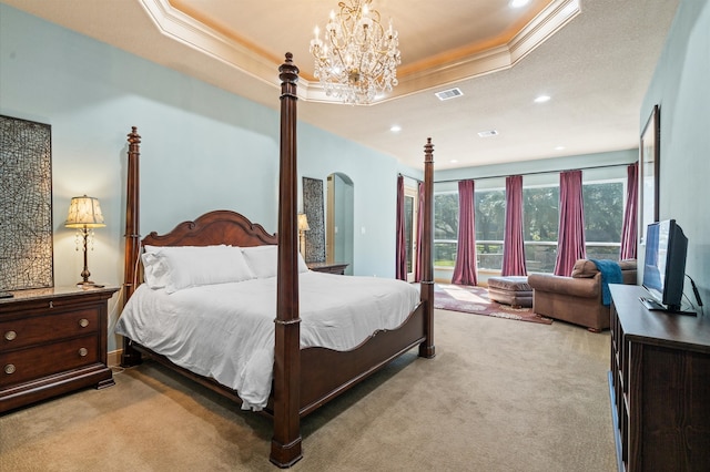 bedroom featuring light carpet, an inviting chandelier, a raised ceiling, and crown molding