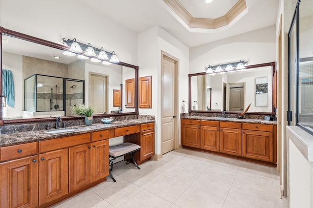 bathroom with vanity, a shower with door, crown molding, tile patterned flooring, and a tray ceiling