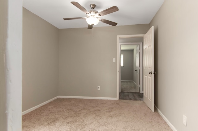 spare room with carpet flooring and ceiling fan