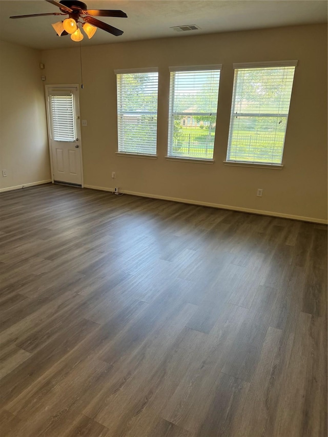 spare room with ceiling fan and dark hardwood / wood-style floors