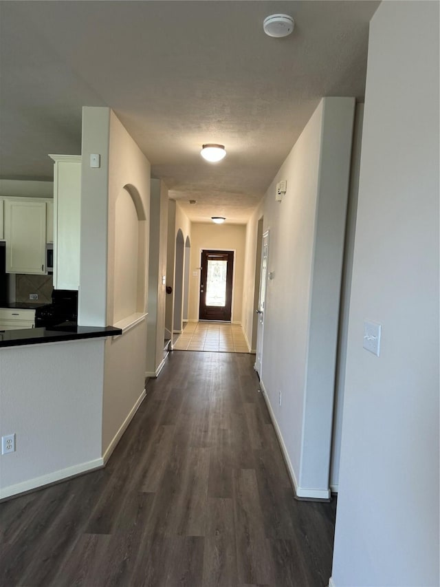 hall with dark hardwood / wood-style flooring