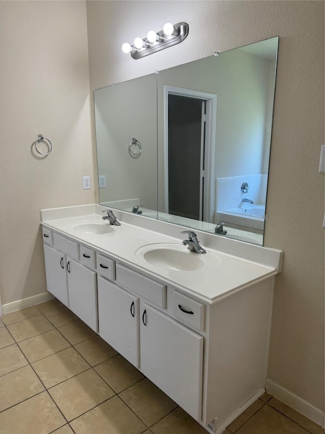 bathroom featuring a bath, tile patterned floors, and vanity